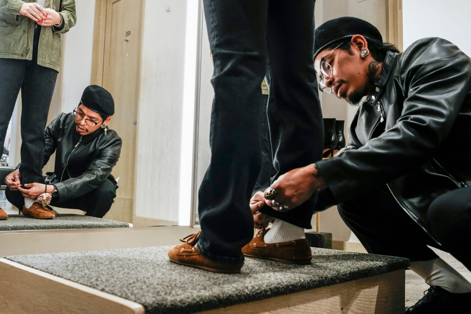 Tailor Marco Lema, 35, of Ecuador, measures a denim alteration at Nordstrom headquarters in New Yor...