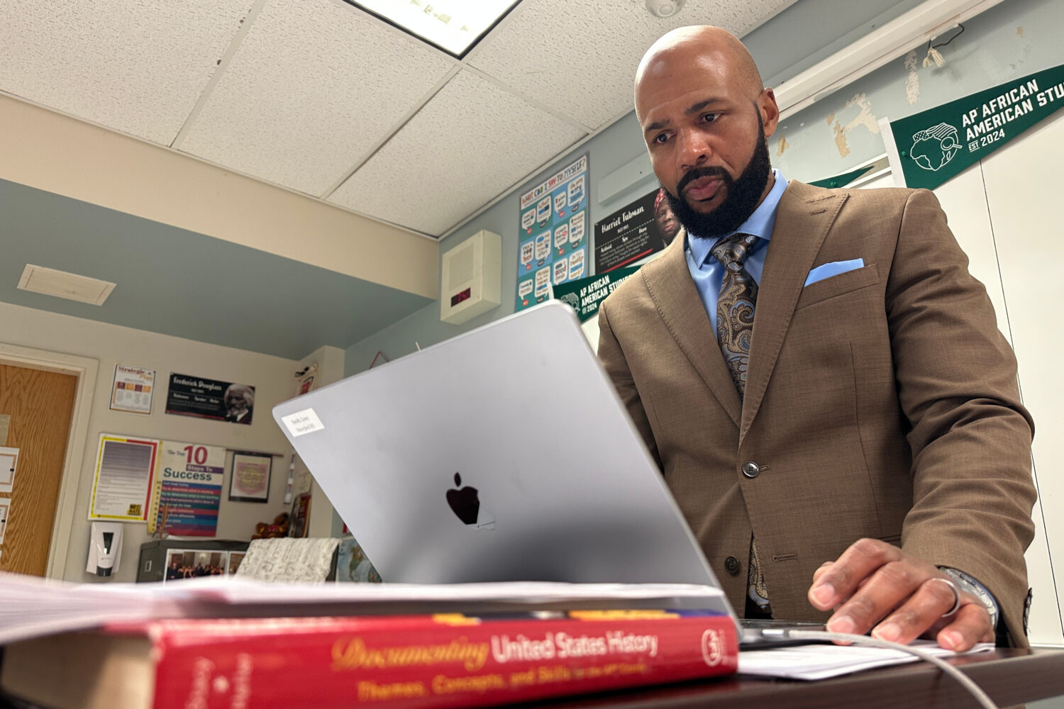 Leon Smith, named the 2026 National Teacher of the Year, stands in front of his classroom at Haverf...