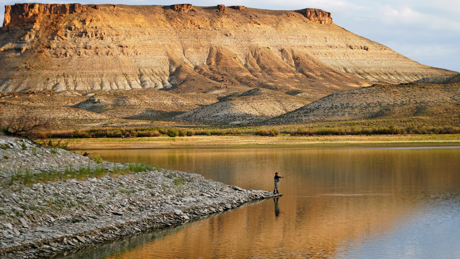 FILE - Nick Gann fishes in Firehole Canyon, Friday, Aug. 5, 2022, on the far northeastern shore of ...