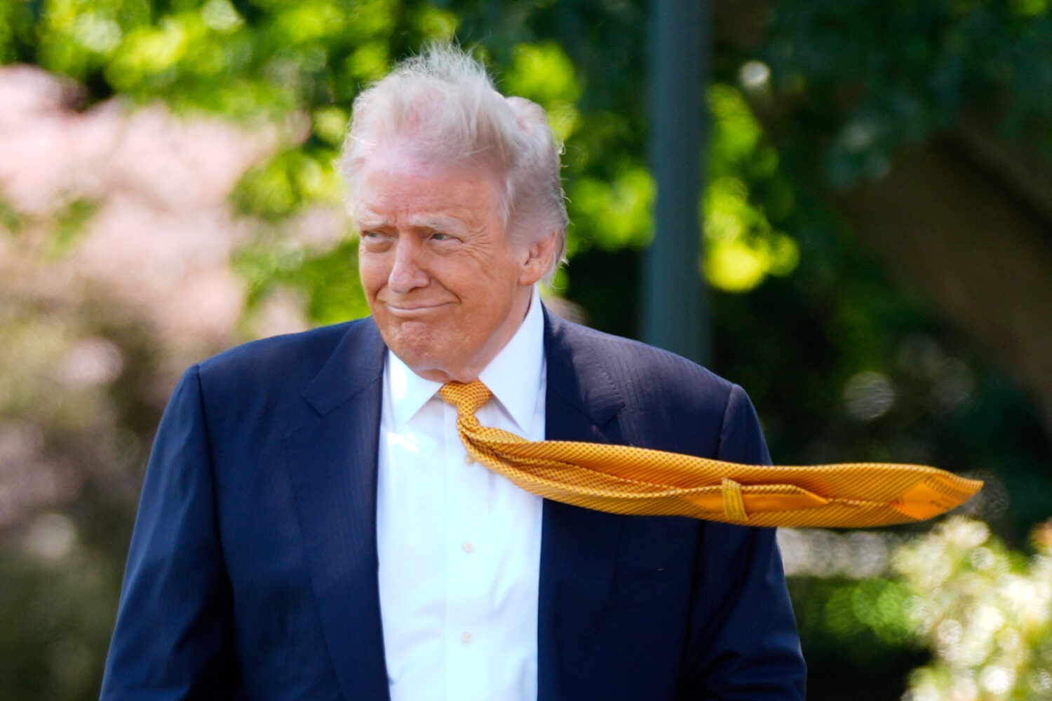 President Donald Trump walks as he leaves the White House for travel to Beijing, Tuesday, May 12, 2...