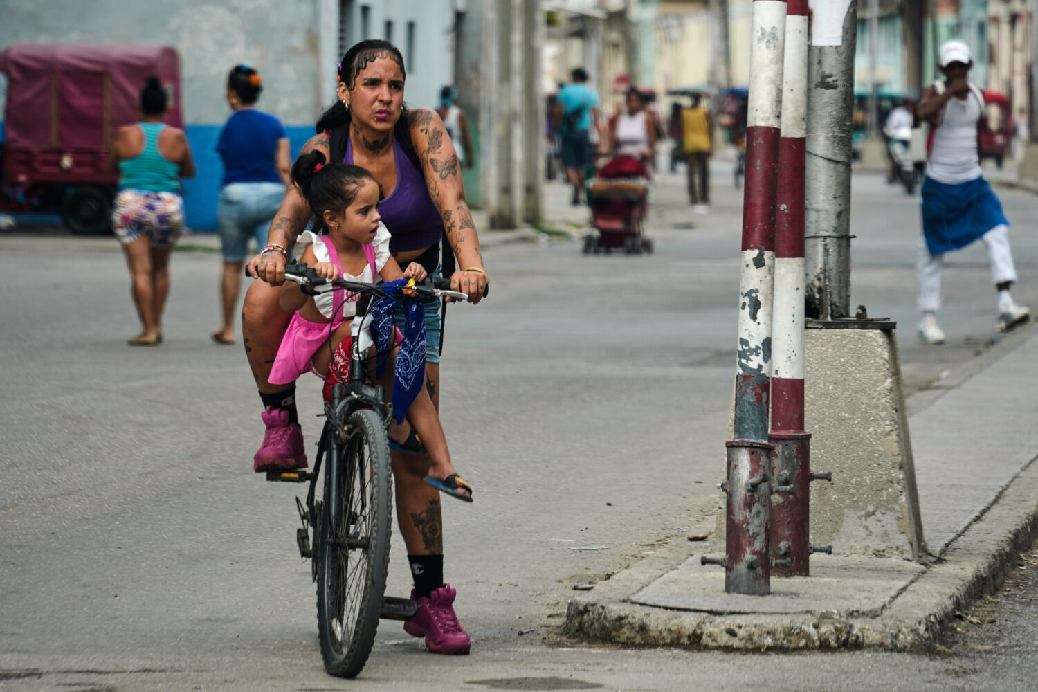 A woman carries a girl on a bicycle in Havana, Cuba, Friday, May 8, 2026. (AP Photo/Ramon Espinosa)...