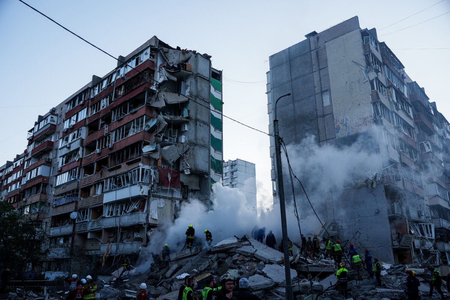 Rescue workers clear the rubble of a house heavily damaged after a Russian strike on a residential ...