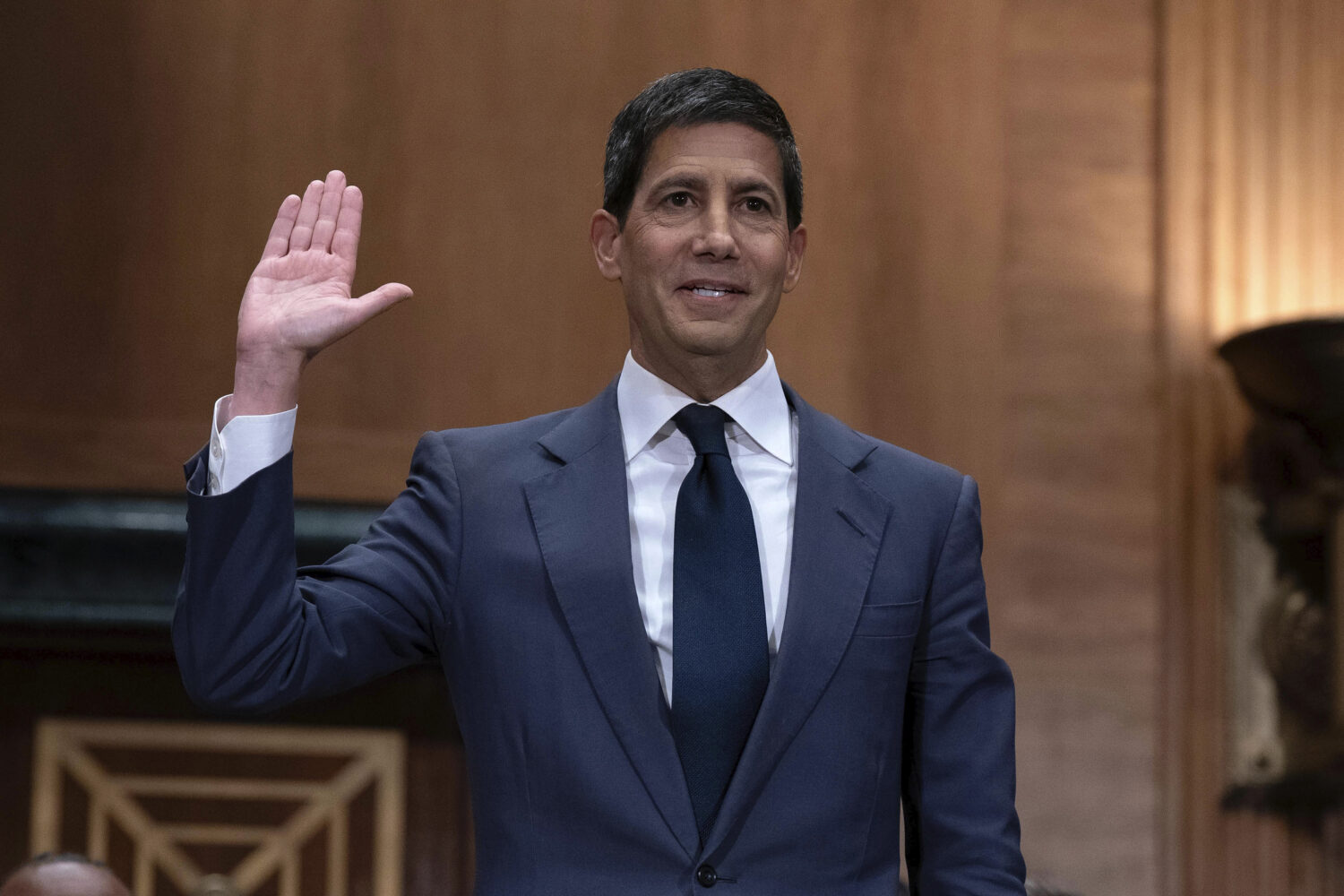 Kevin Warsh is sworn in during his nomination hearing to be a member and chairman of the Federal Re...