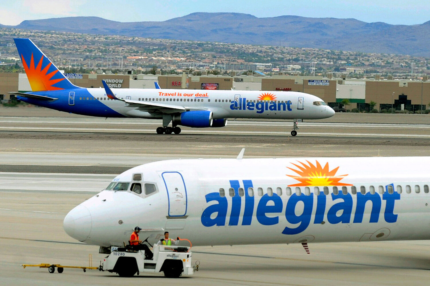 File - In this May 9, 2013, file photo, two Allegiant Air jets taxi at McCarran International Airpo...