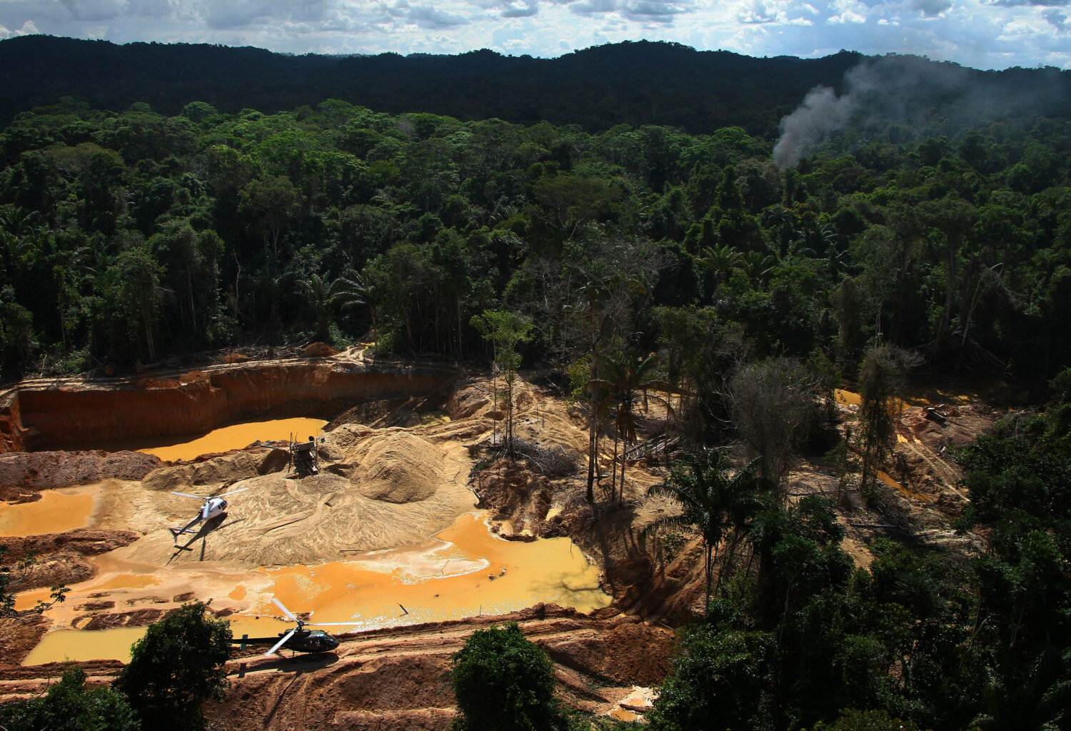 FILE - Helicopters are visible at an illegal mining camp during an operation by Brazil's environmen...
