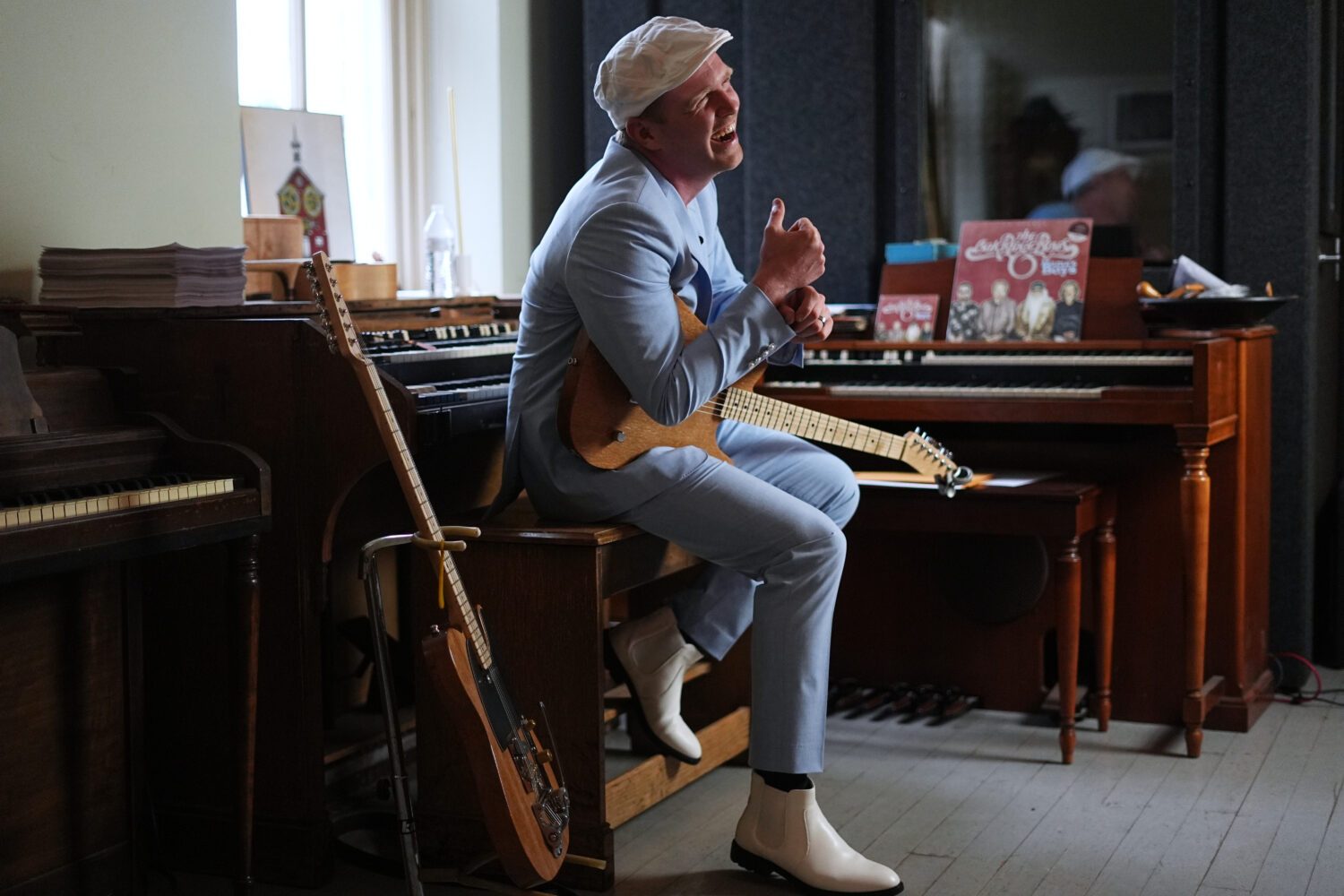 Conrad Fisher laughs during an interview with the Associated Press ahead of his performance at Raga...