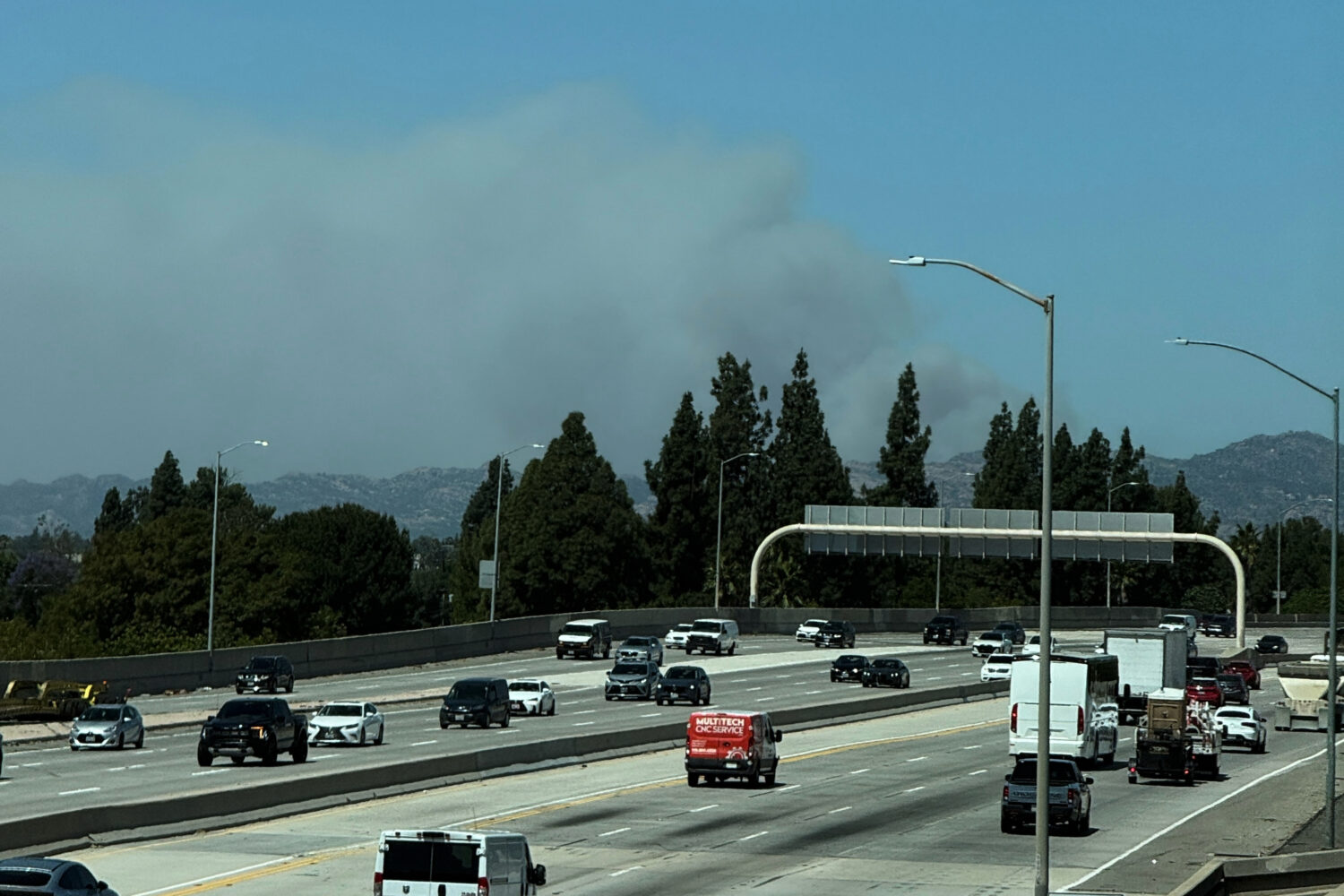 A plume of smoke from the Sandy Fire rises over the 118 freeway Monday, May 18, 2026, in Los Angele...