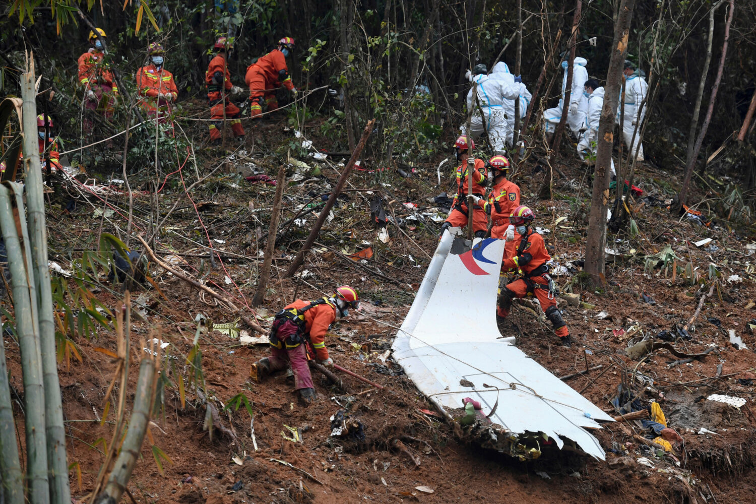 FILE - In this photo released by Xinhua News Agency, search and rescue workers search through debri...