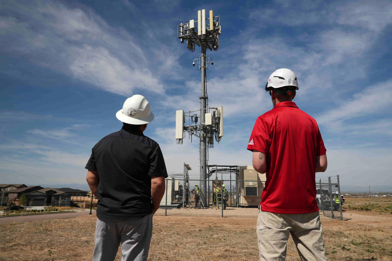 Workers observe a tower where Pano AI cameras are installed for detecting wildfires Monday, April 2...