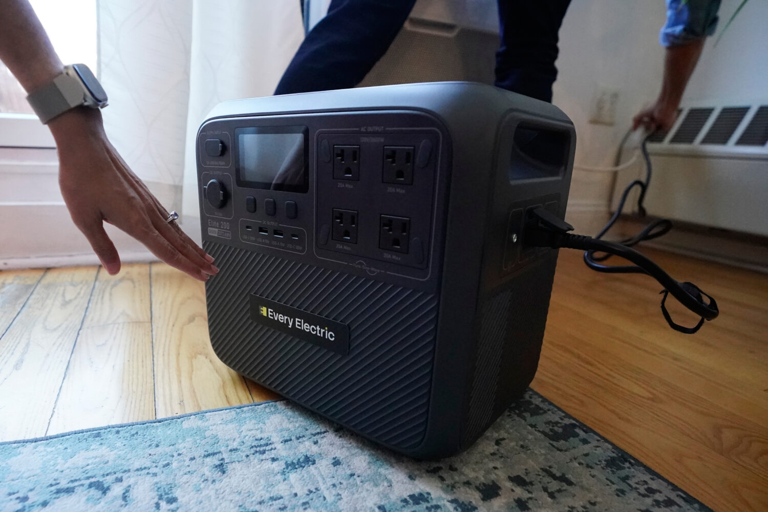 Sonam Velani and Yan Sim plug in a battery from Every Electric to power an air conditioner as part ...