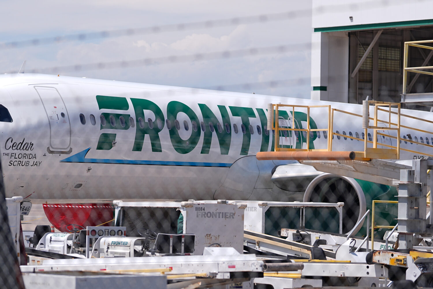 Frontier Airlines jetliner number n646fr sits outside the airlines technical operations center with...