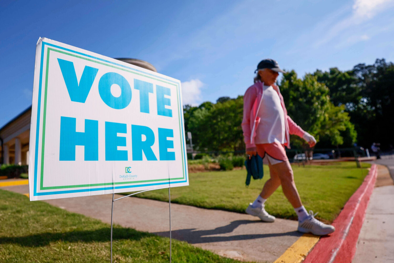 A person walks past a voting sign during the first day of early voting for the primary elections at...