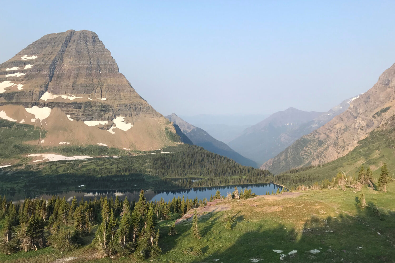 Mount Brown, second peak from left, is tucked behind Bearhat Mountain, far left, at Glacier Nationa...