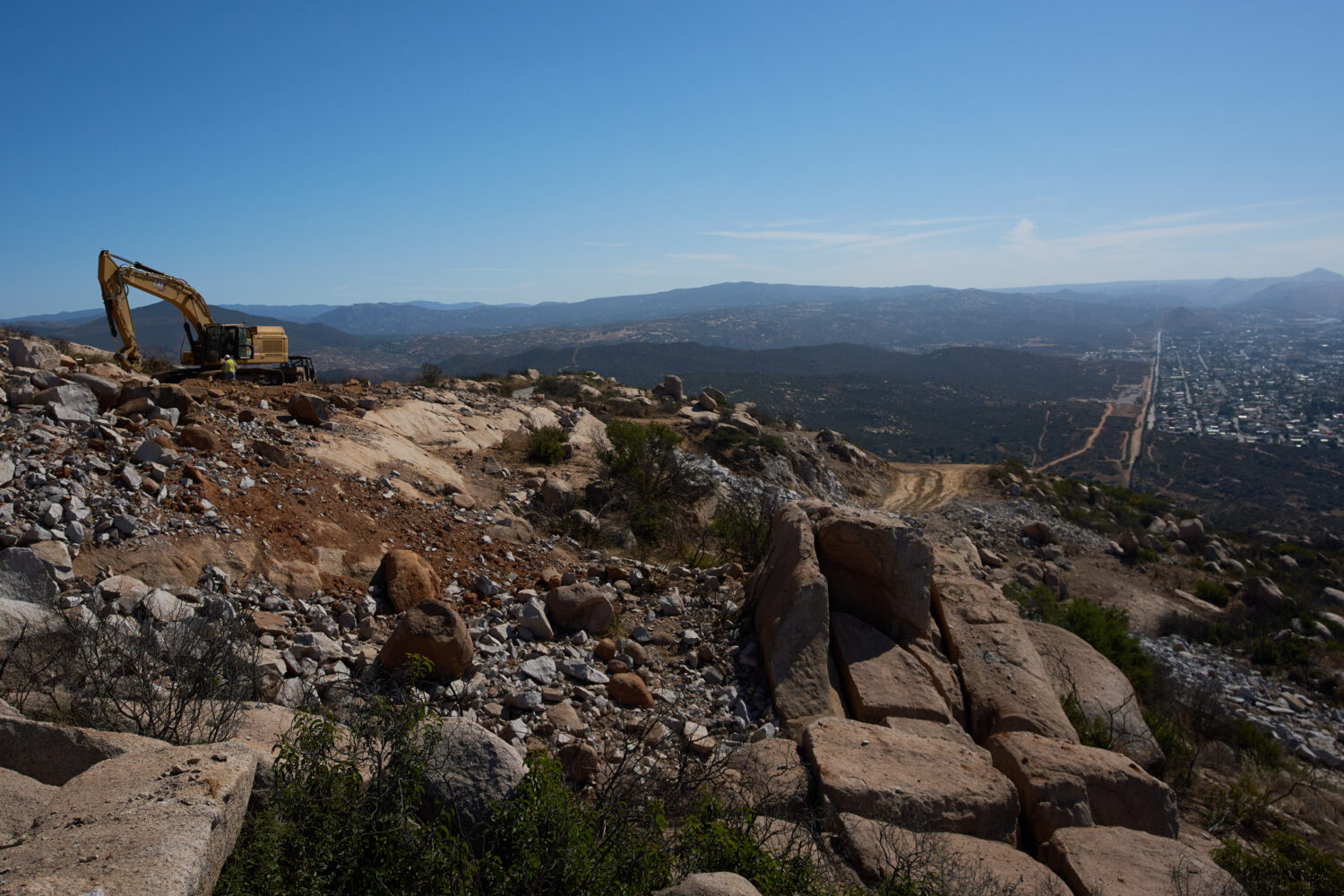 Construction crews work on a new border wall segment on Kuuchamaa Mountain, Friday, April 24, 2026,...