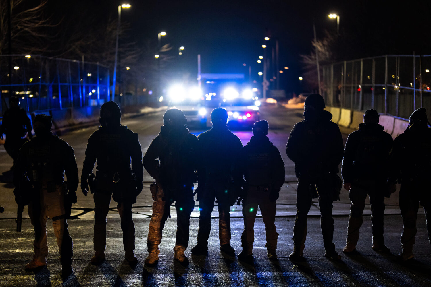 FILE - Federal officers stand guard after detaining people outside of Bishop Henry Whipple Federal ...