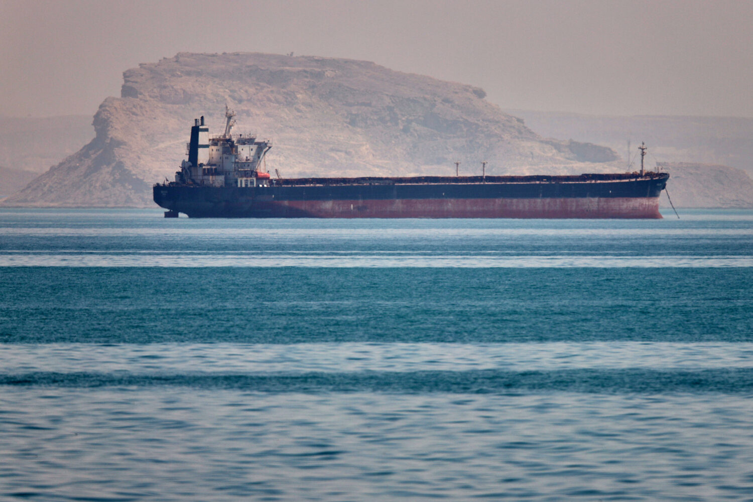 A bulk cargo ship sits at anchor in the Strait of Hormuz off Bandar Abbas, Iran, Saturday, May 2, 2...