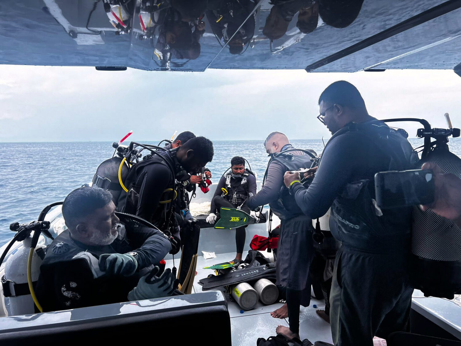 This image released by the Maldives President's Media Division, shows divers preparing to search fo...