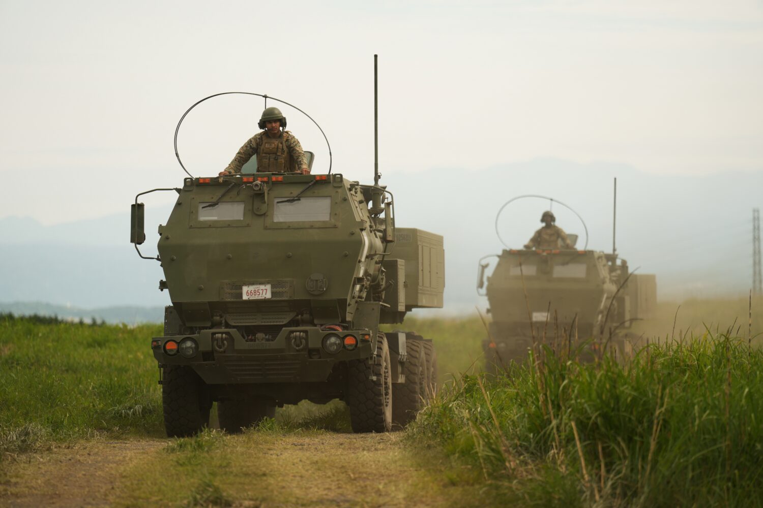 U.S. Marines appear to show the High Mobility Artillery Rocket System (HIMARS) mounted on trucks du...