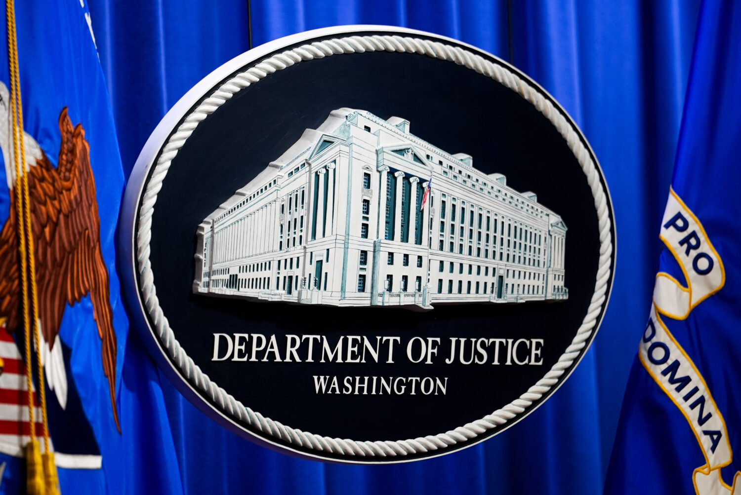 The U.S. Department of Justice logo is before a news conference, Monday, May 4, 2026, in Washington...