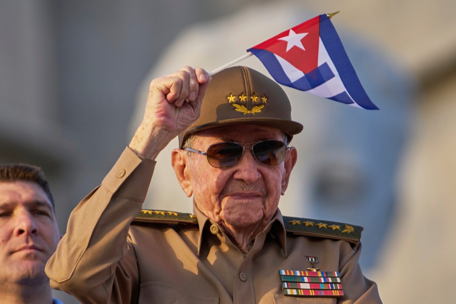 FILE - Raul Castro waves a Cuban national flag during a May Day parade at Revolution Square in Hava...