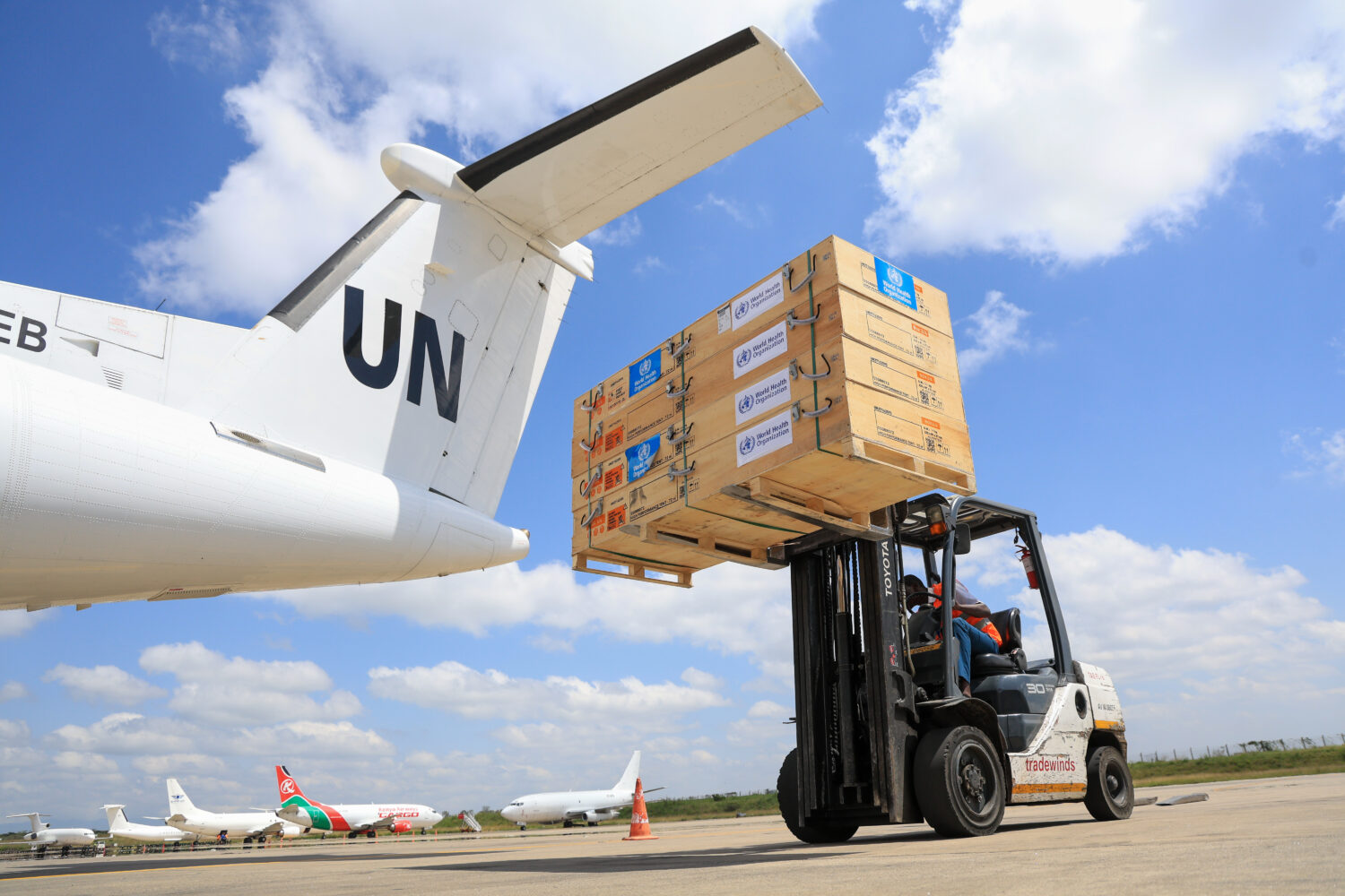 Workers load World Health Organization (WHO) emergency supplies onto a United Nations plane in Nair...