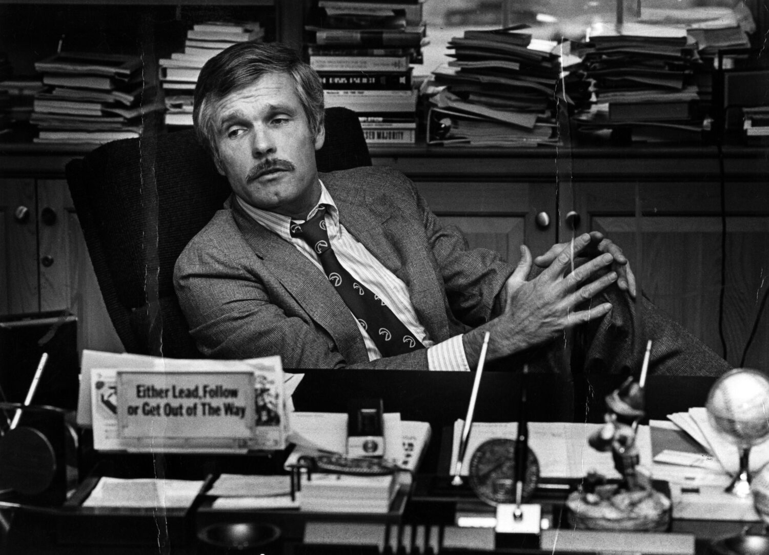 FILE - Ted Turner is seen at his desk inside the CNN Center in 1982. (Nancy Mangiafico/Atlanta Jour...