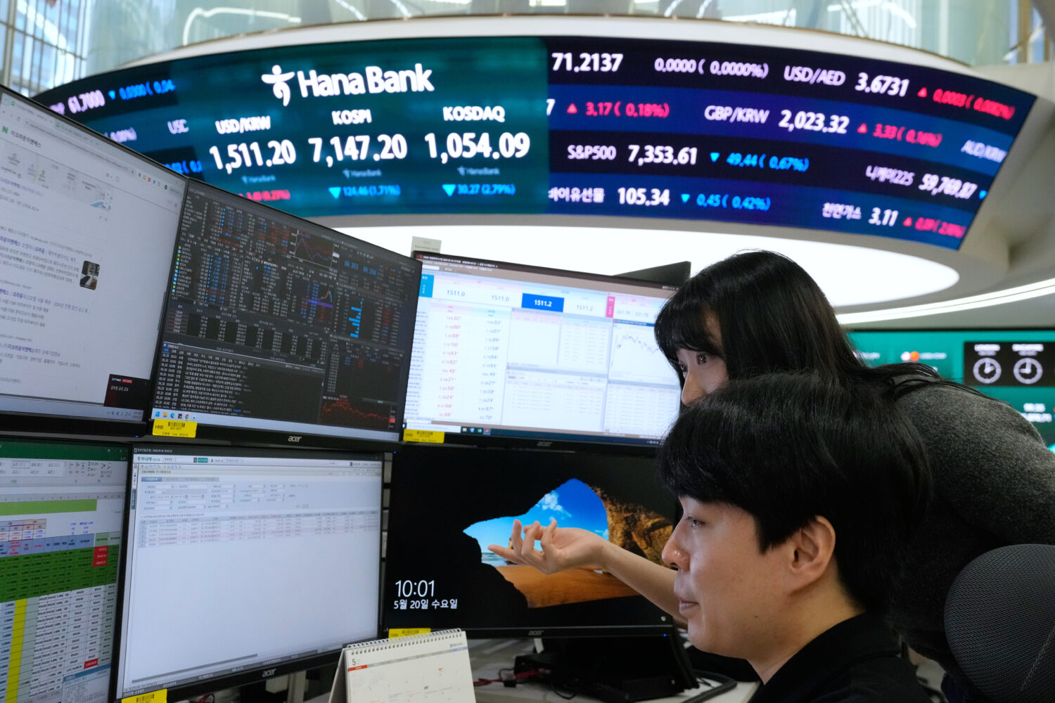 Currency traders watch monitors at the foreign exchange dealing room of the Hana Bank headquarters ...