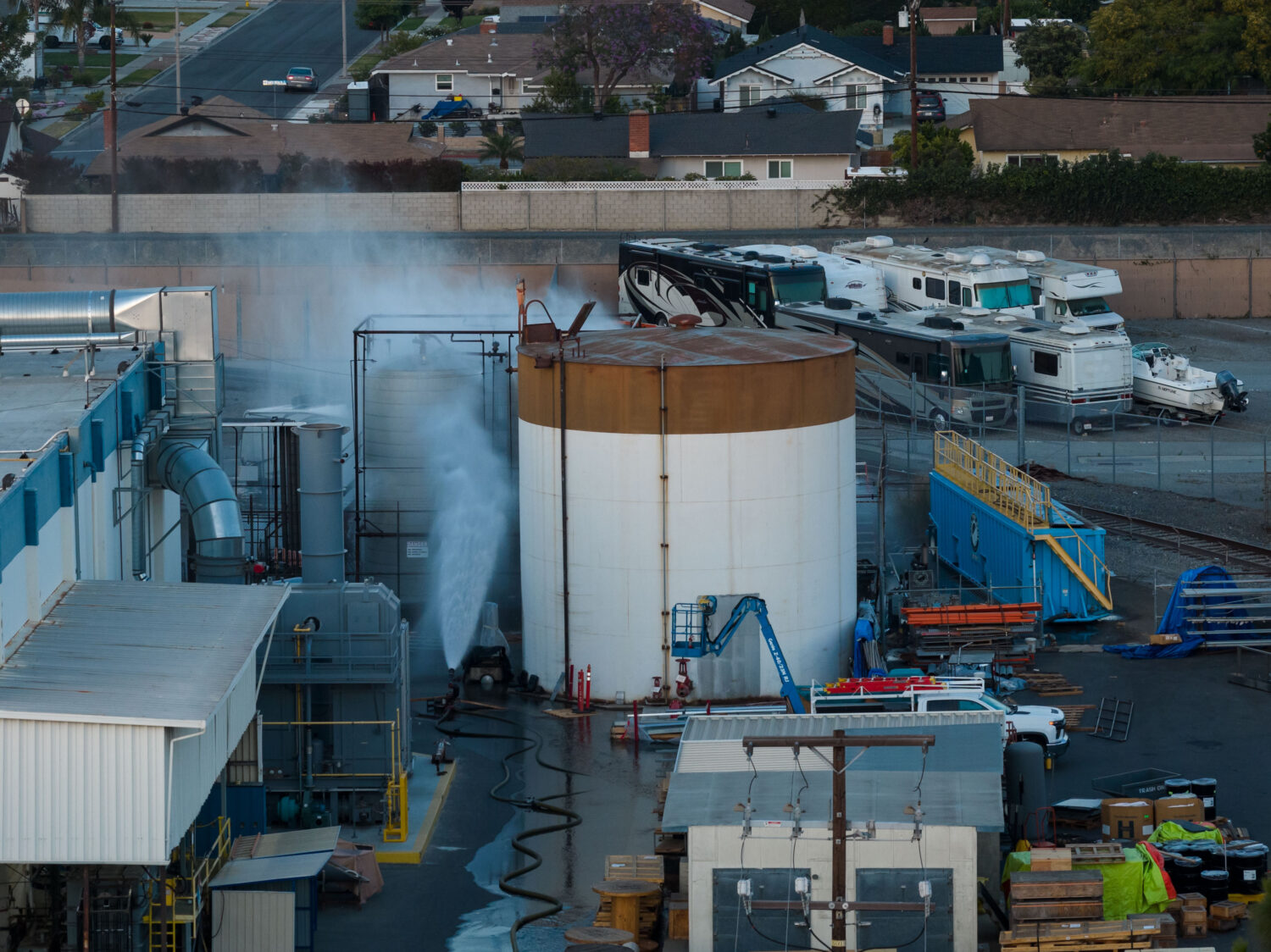 Water is sprayed on a tank that overheated at an aerospace plant in Garden Grove, Calif., Friday, M...
