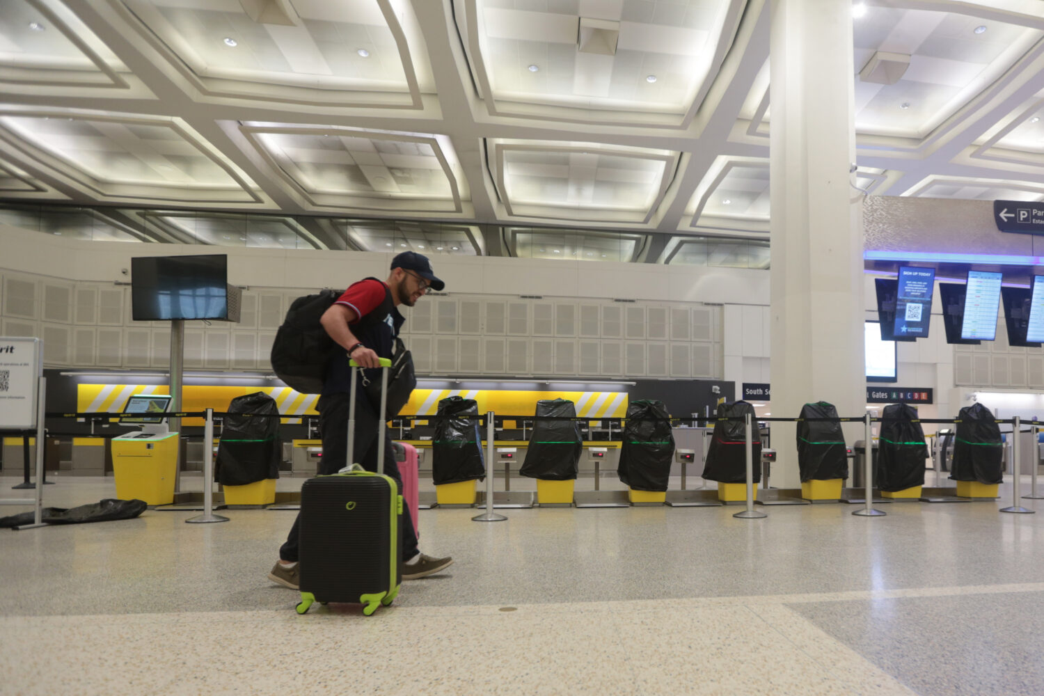 A traveler walks past covered Spirit Airlines kiosks, Saturday, May 2, 2026, at George Bush Interco...