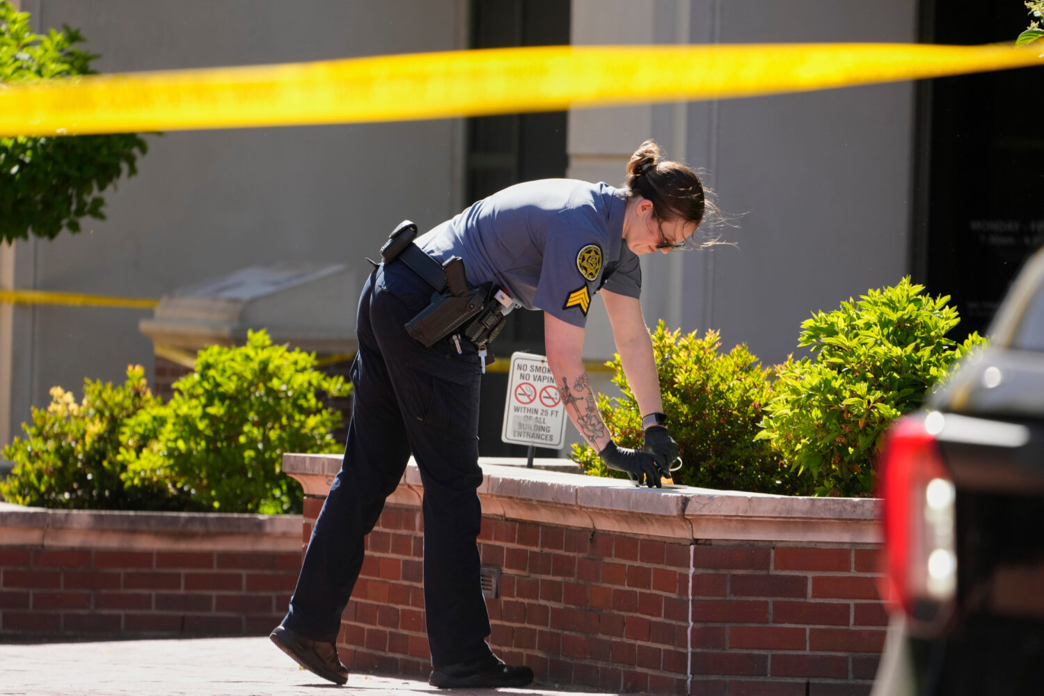 A Sheriff's deputy investigates a shooting scene outside the Montgomery County Courthouse, Wednesda...