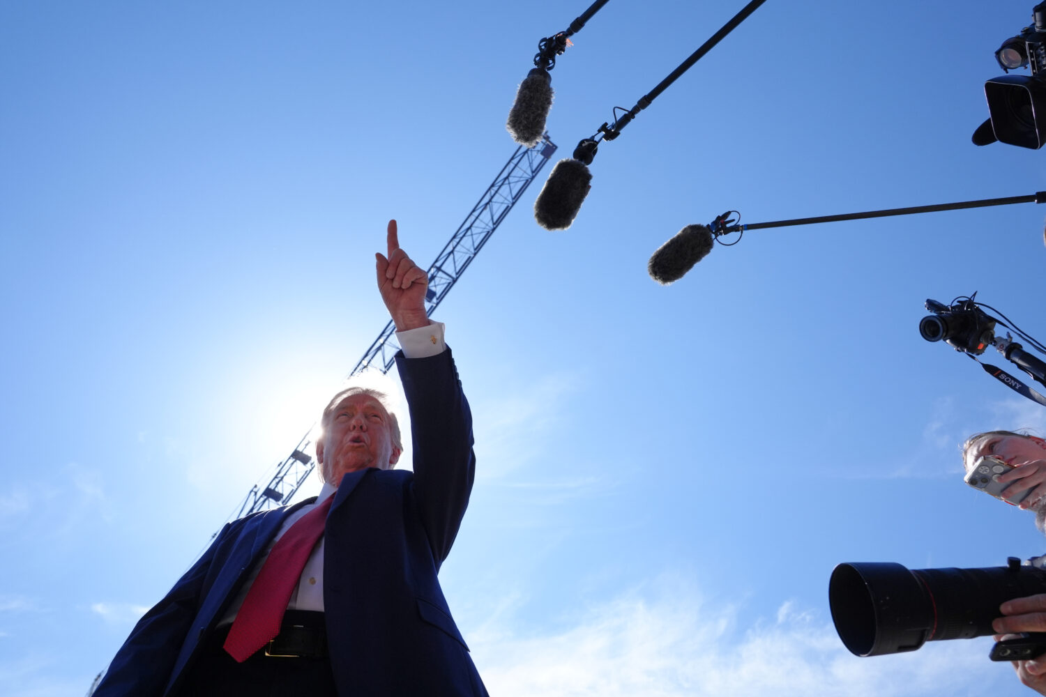 President Donald Trump speaks as he tours Ballroom construction around the outside the White House,...