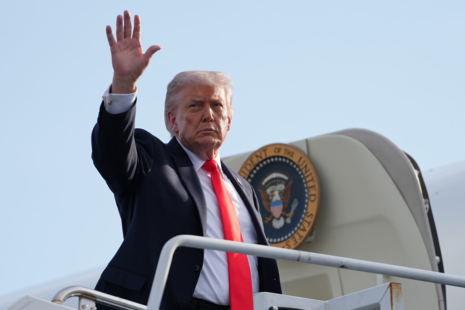 President Donald Trump boards Air Force One at Ocala International Airport, in Ocala Fla., Friday, ...