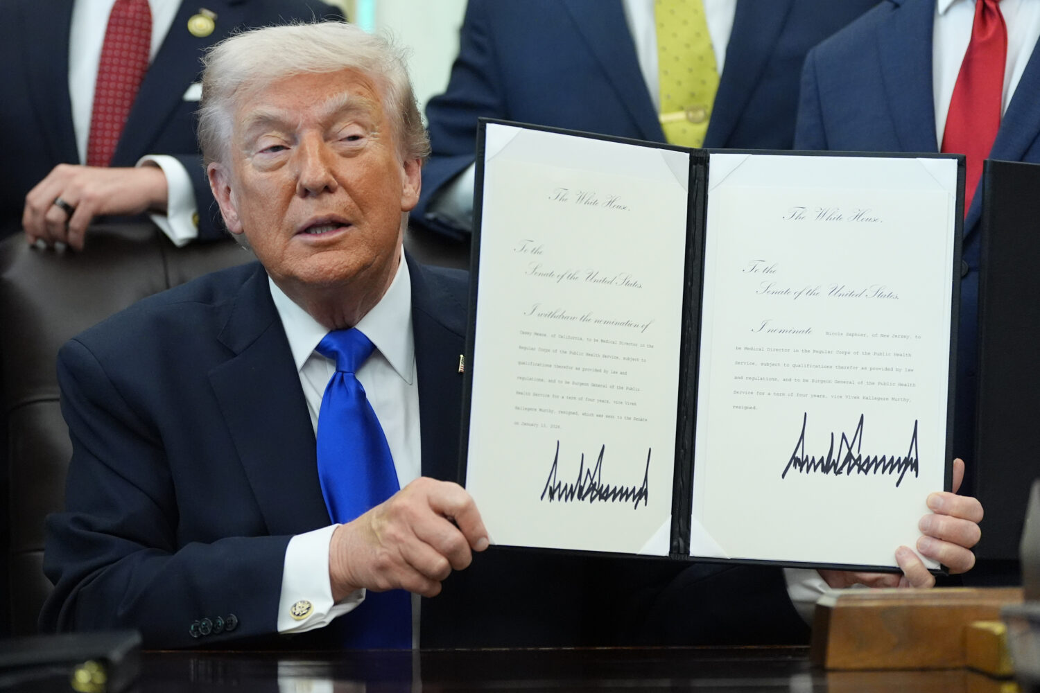 President Donald Trump signs documents regarding the withdrawal of the current nomination and nomin...