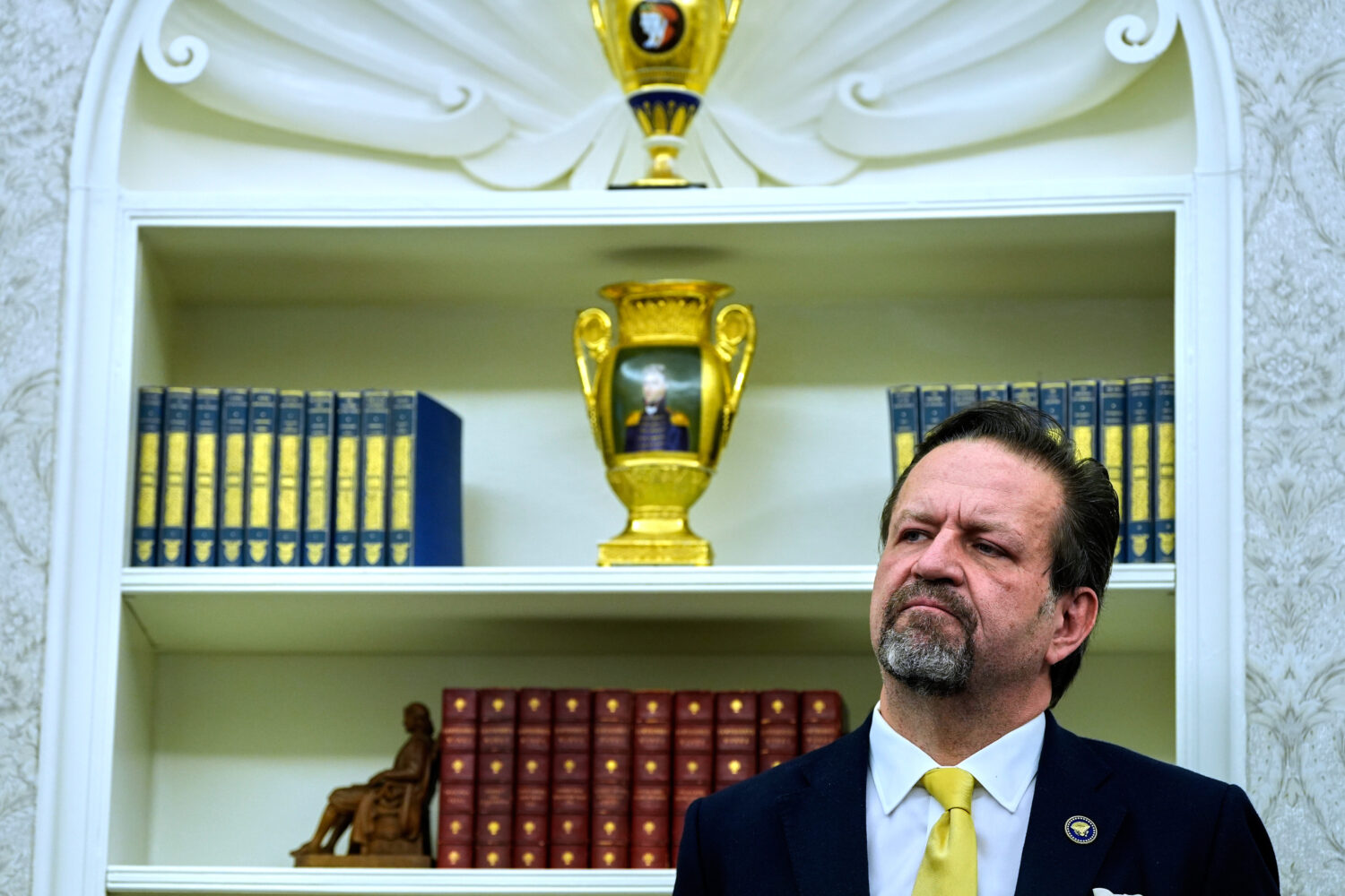 FILE - Sebastian Gorka listens as President Donald Trump speaks with reporters after signing execut...