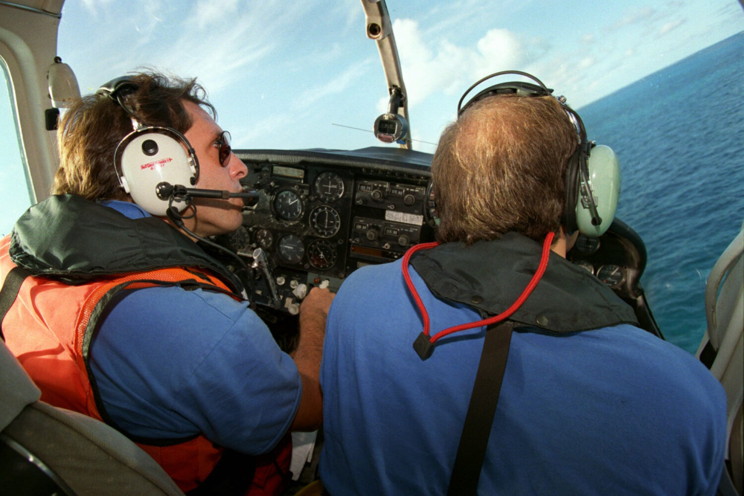 FILE - Brothers to the Rescue pilot Ivan Domaniewicz, left, and co-pilot Carlos Costa fly over the ...