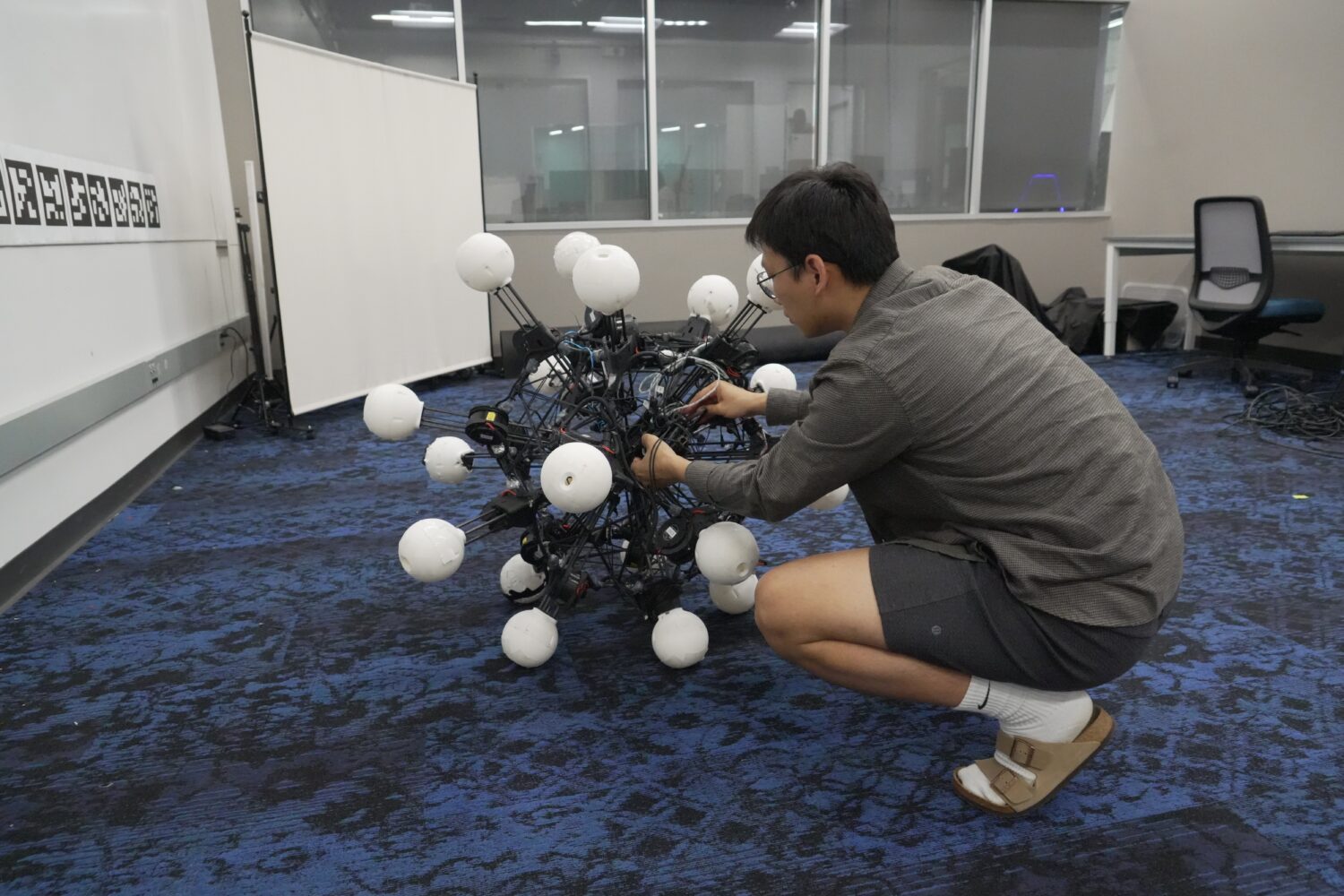 Jiaxun Liu, a Ph.D. student, works on a robot named Argus at Duke University's General Robotics Lab...