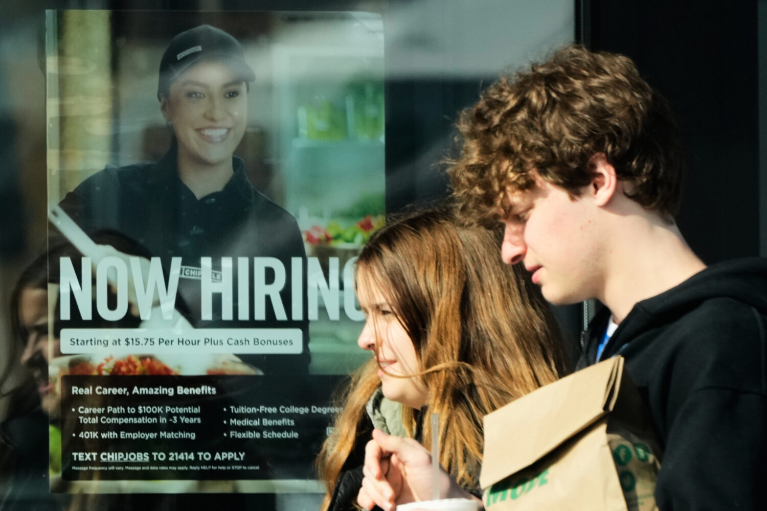 A hiring sign is displayed at a restaurant, in Niles, Ill., Tuesday, April 7, 2026. (AP Photo/Nam Y...