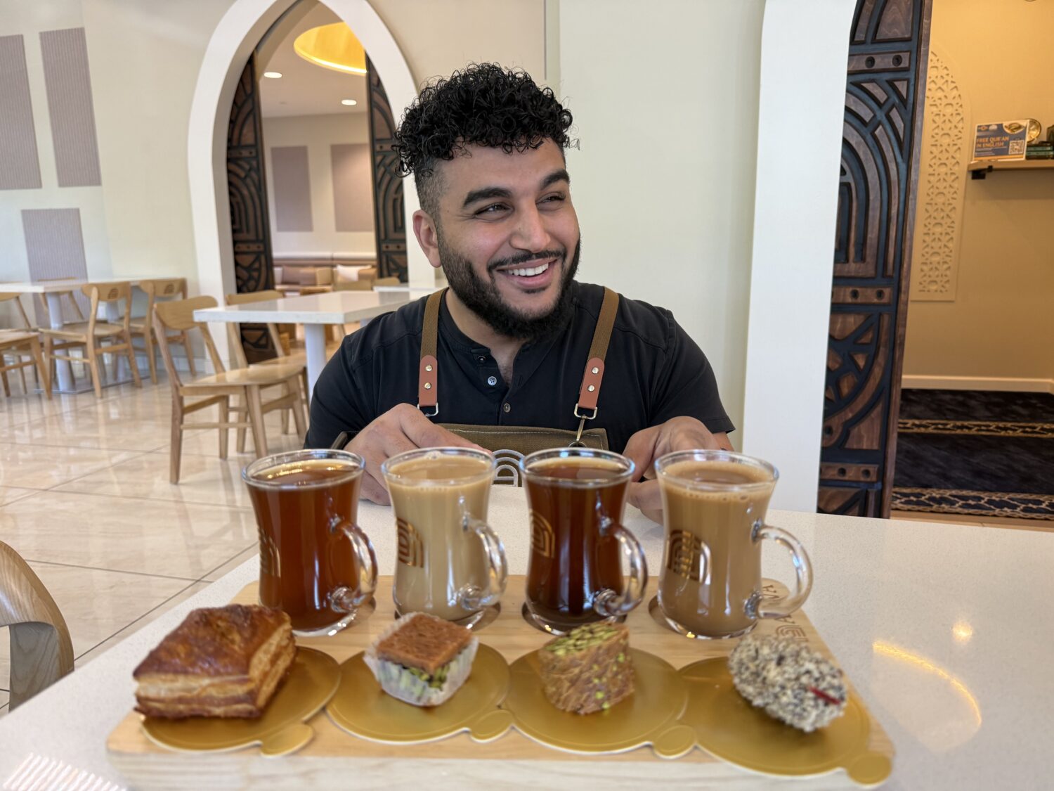 Franchisee Ahmad Badr serves a drink and treat sampler at Arwa Yemeni Coffee on April 6, 2026, in S...