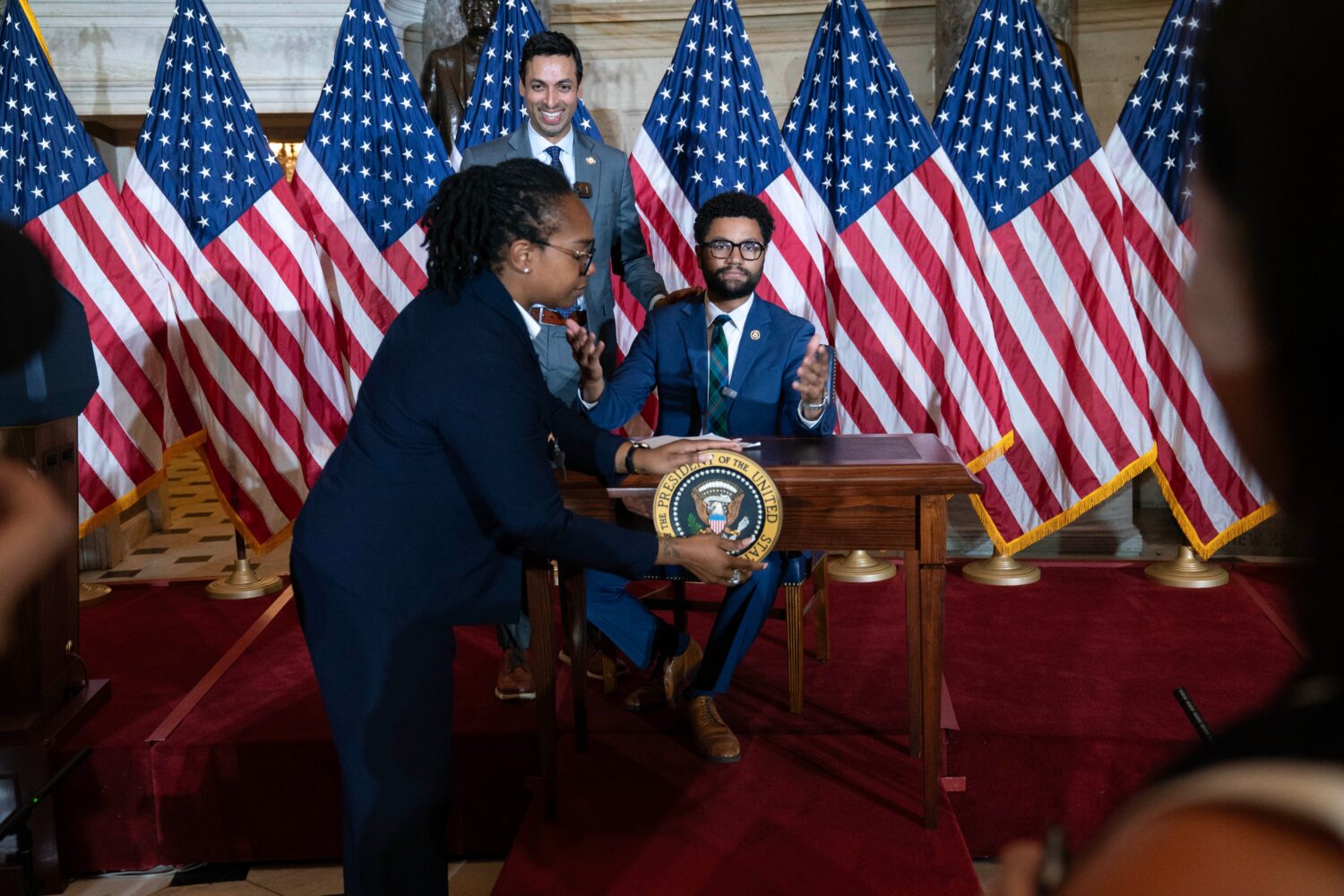 Rep. Suhas Subramanyam, D-Va., left, and Rep. Maxwell Frost D-Fla., speaks at a desk prepared for P...