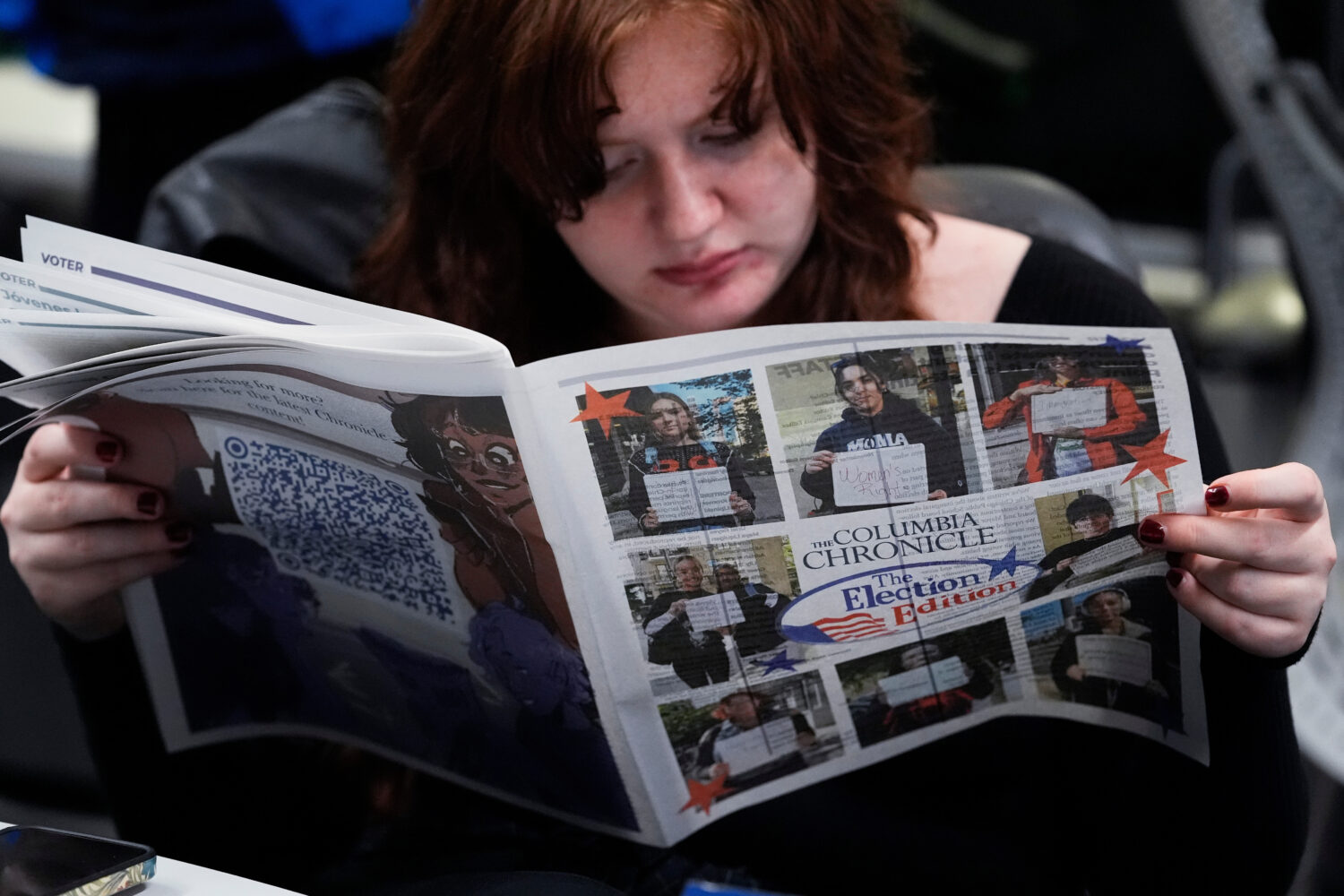 FILE - Columbia College Chicago student Kailey Ryan reads a newspaper in Chicago, Nov. 5, 2024. (AP...