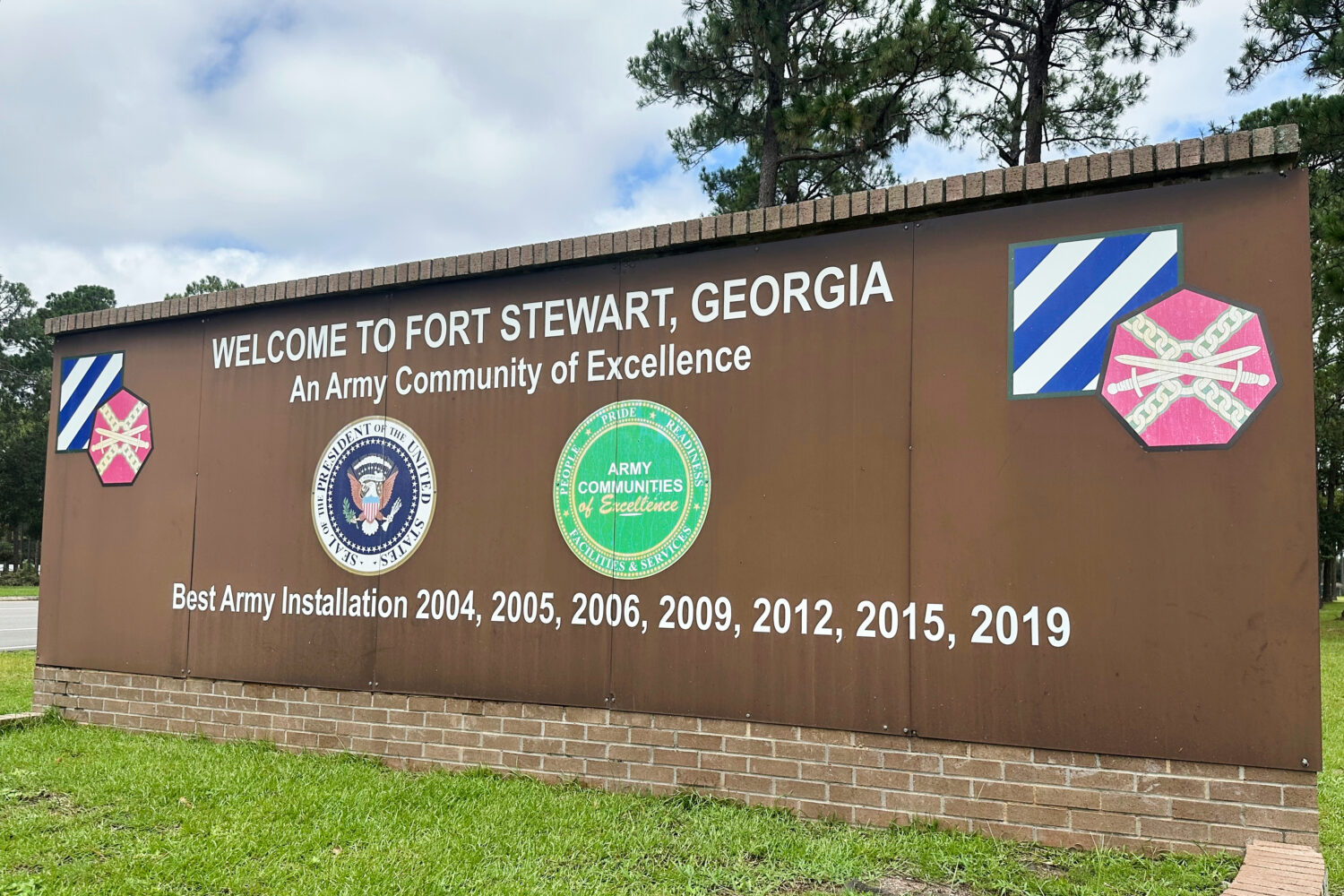 FILE - A sign stands outside the main gate of Fort Stewart, Georgia, on Wednesday, Aug. 6, 2025. (A...