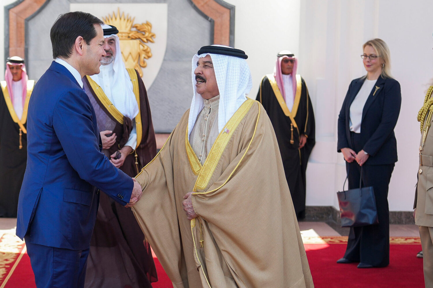 U.S. Secretary of State Marco Rubio, left, and Bahrain's King Hamad bin Isa Al Khalifa salute eacho...