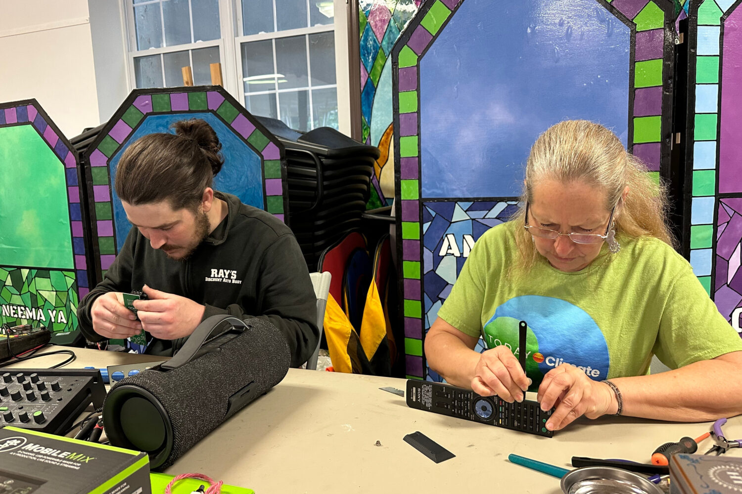 Electronic repair coach Dan Casey and his mother Diane Casey work on a sound-mixing device at a Rep...