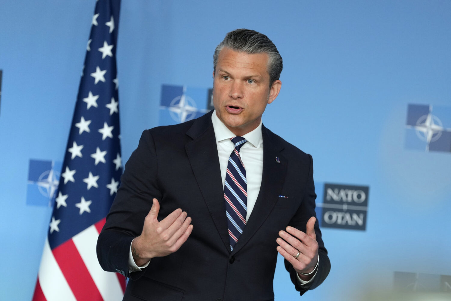United States Defense Secretary Pete Hegseth speaks during a press statement on arrival for a meeti...