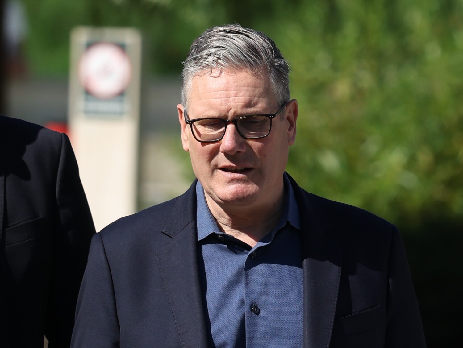 Britain's Prime Minister Keir Starmer walks, as he visits a housing development in north London, Fr...