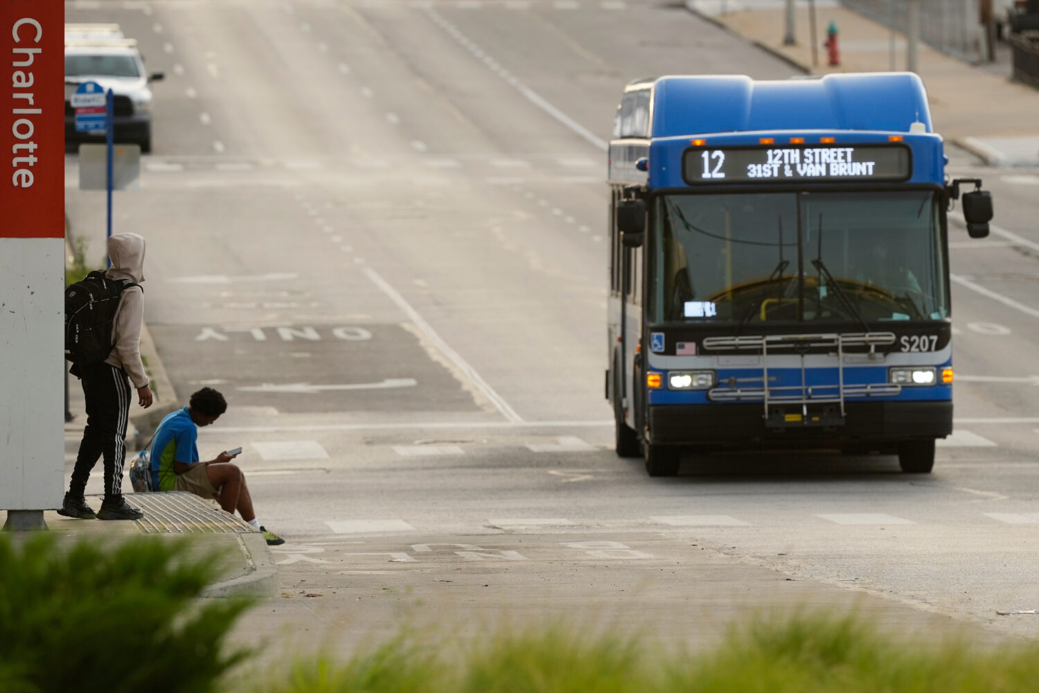 People wait for the bus at a transit center Friday, June 5, 2026, in Kansas City, Mo. (AP Photo/Cha...