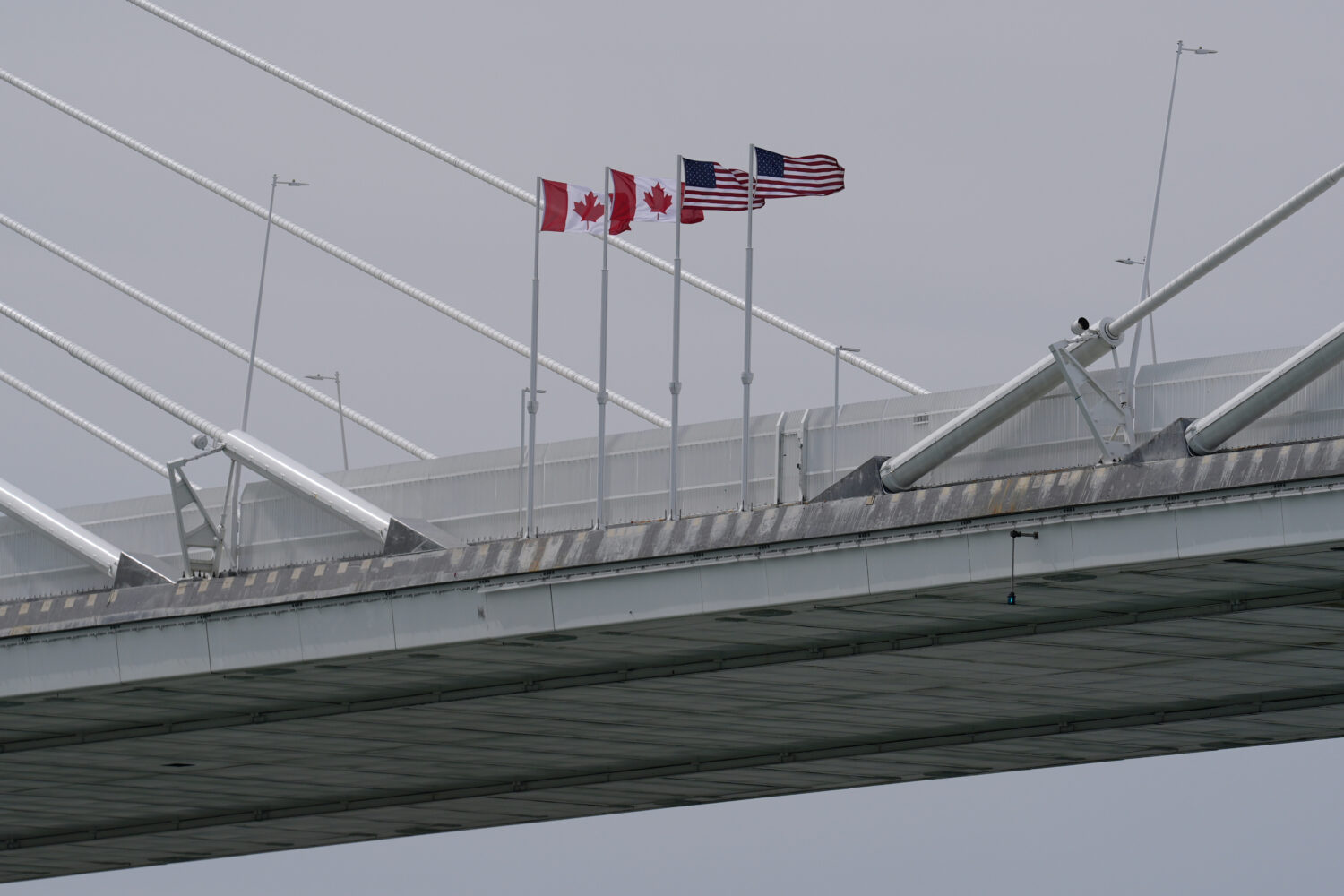 FILE - Canadian and American flags are shown on the Gordie Howe Bridge under construction between W...