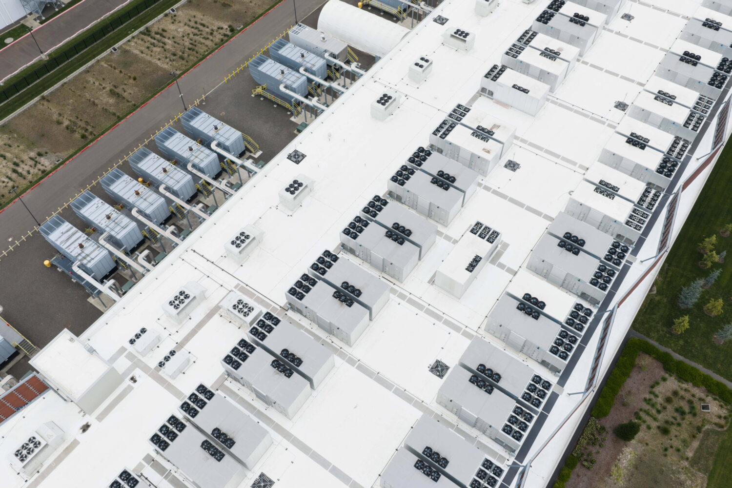 FILE - Fans, part of a cooling system, are visible on the roof of a data center April 27, 2026, in ...