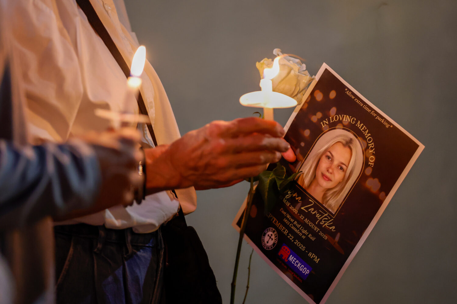 FILE - Community members hold candles as they gather for a vigil honoring the life of Iryna Zarutsk...