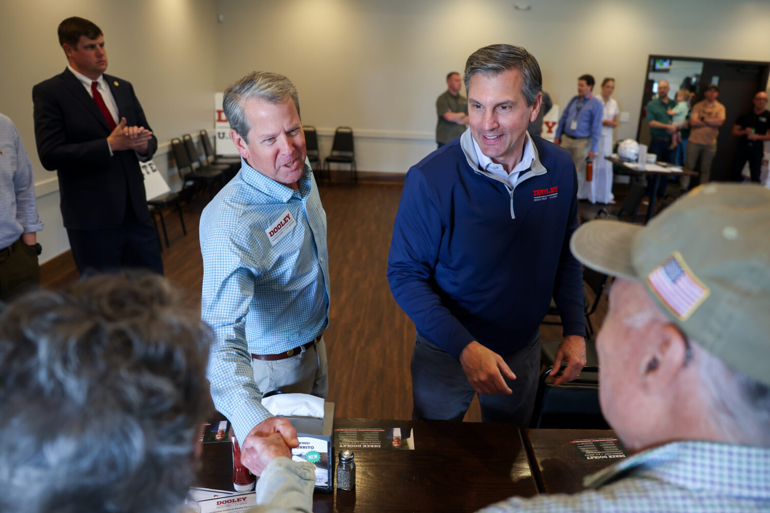 FILE - Gov. Brian Kemp, center left, and Republican U.S. Senate candidate Derek Dooley greet suppor...